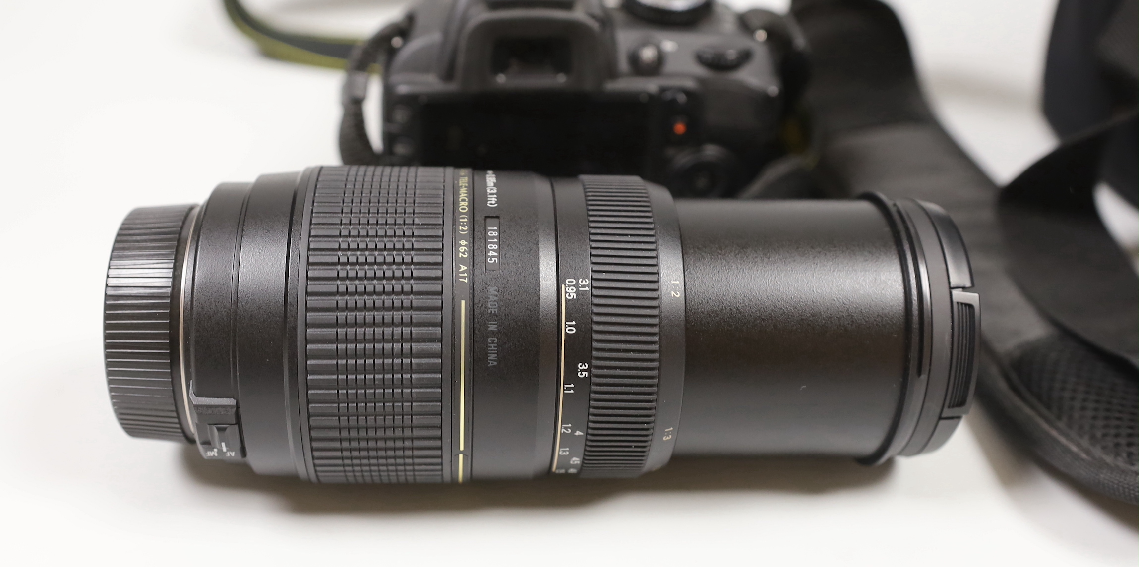 A Nikon D3100 digital camera, together with a Tamron Telephoto Lens and carrying case